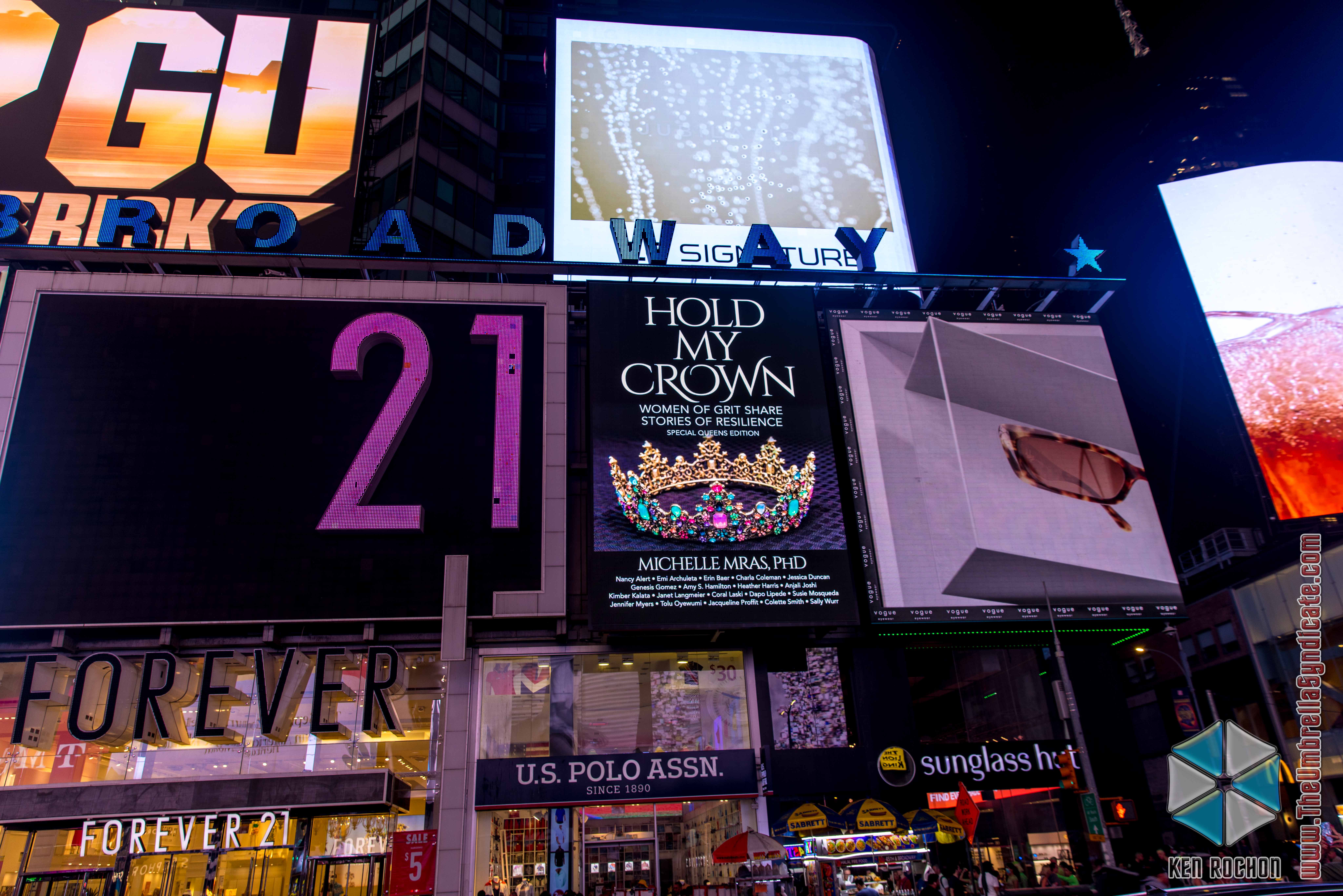 A picture of the book, Hold My Crown, featured in Times Square.